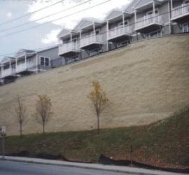tall segmental retaining wall with parking above wall