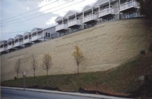 tall segmental retaining wall with parking above wall