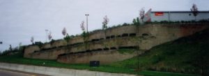 Tiered retaining wall with retail parking area above