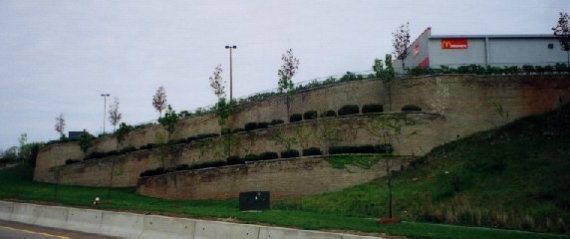 Tiered retaining wall with retail parking area above
