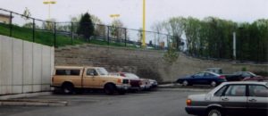 Retail parking area with segmental retaining wall abutting concrete panels